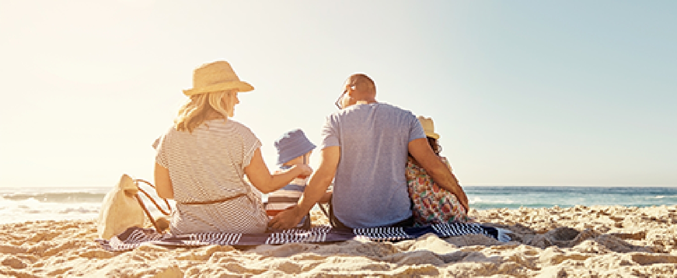 a family sitting on the beach