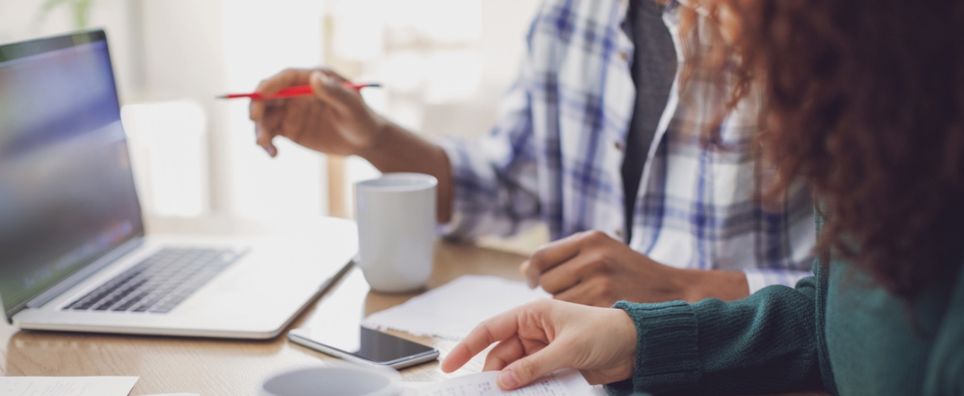 A couple reviewing their financial status at a desk