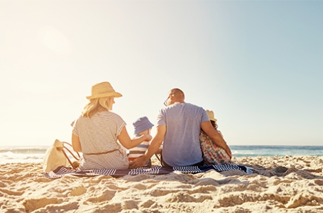 a family sitting on the beach