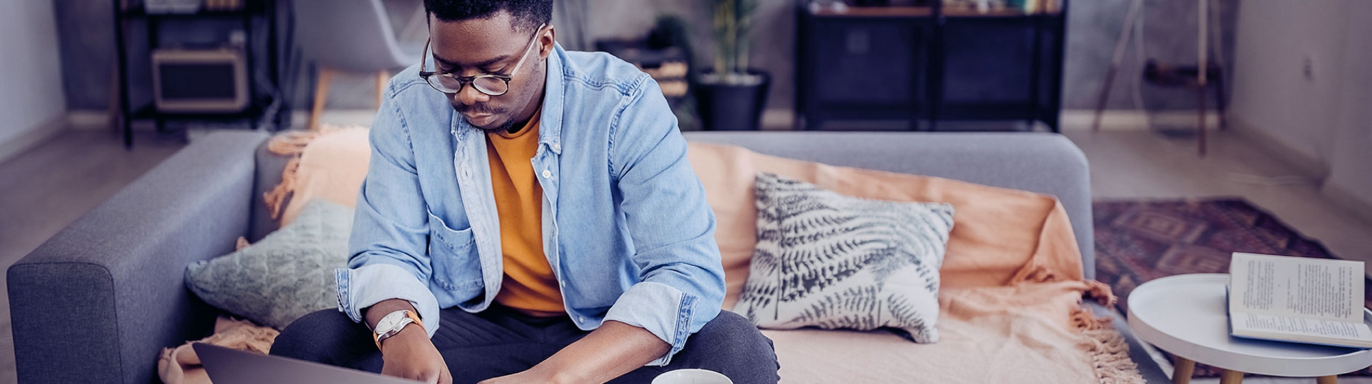 Young man looking on his laptop for debt consolidation loans