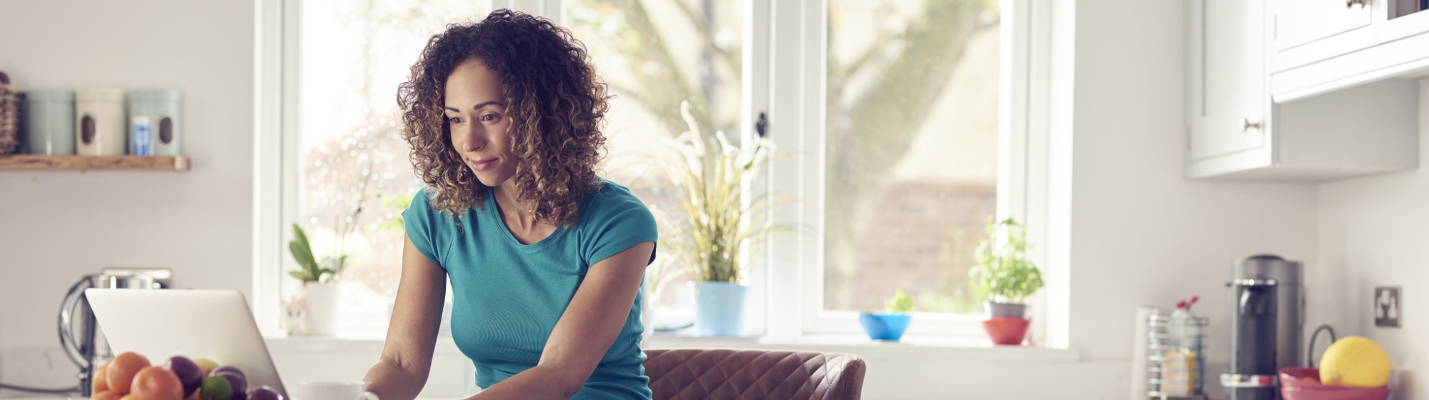 middle aged woman going over loans on the computer