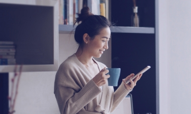 woman looking on her phone at affinity financial videos