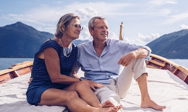 Older couple enjoying a sunset on a boat