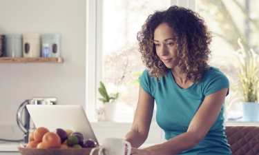 middle aged woman going over loans on the computer