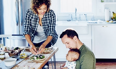 family sitting at the kitchen table eating a meal