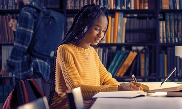 Female student studying in a library