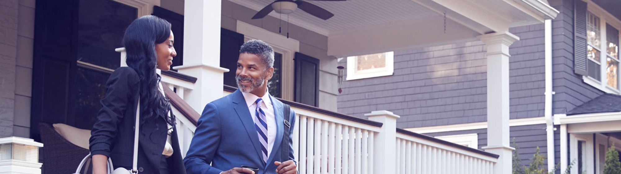 Husband and Wife walking out of their new house