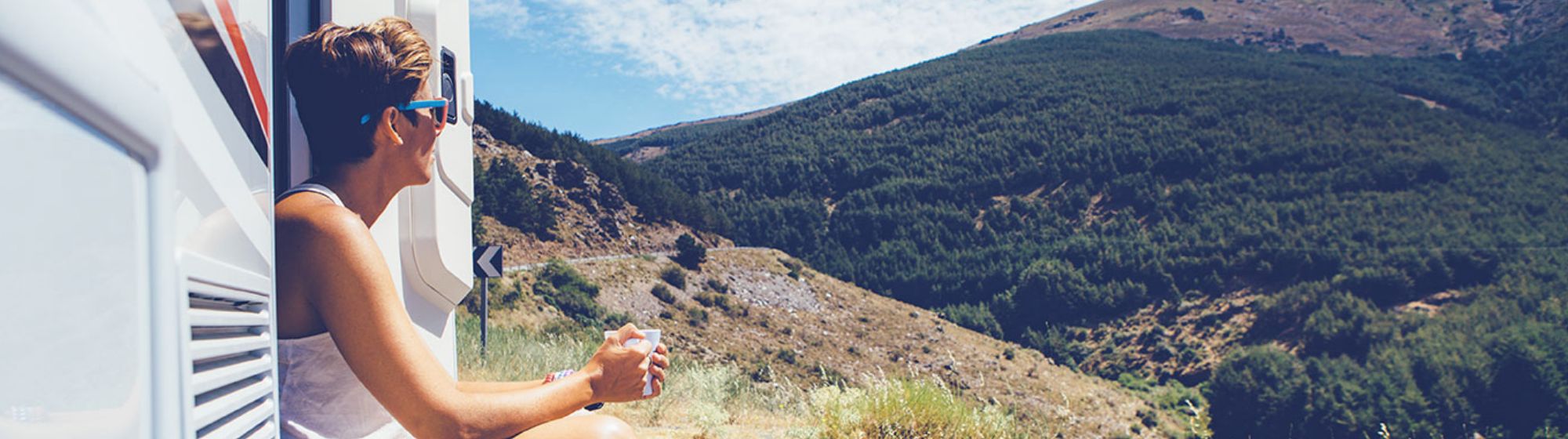 young woman enjoying the view from her rv