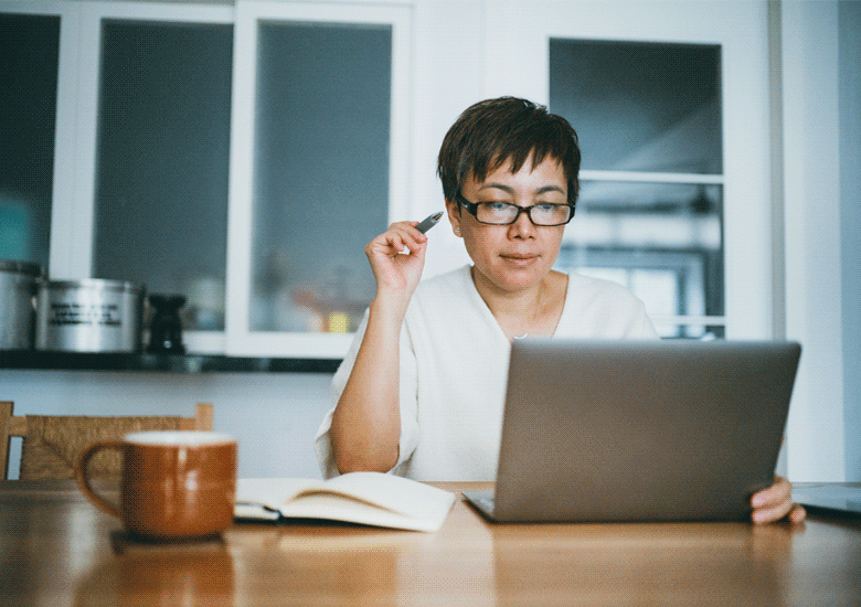 Senior woman working on her retirement plans with laptop at home